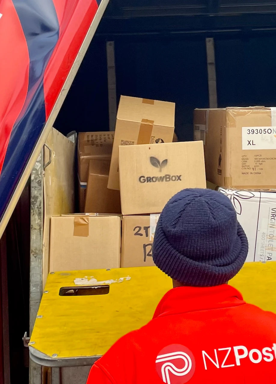 An NZ Post courier loading a GrowBox for delivery